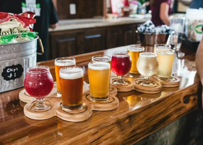 meritt-thomas-OGTEP0LyYNk-unsplash Side view of a selection of glasses with different types of cider